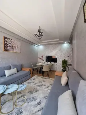 a living room with a couch and a table at Modern Fully equipped 2 rooms apartment in Marrakech