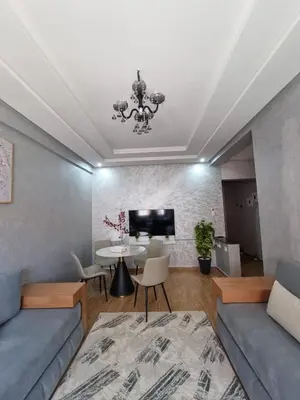 a living room with a couch and a table at Modern Fully equipped 2 rooms apartment in Marrakech