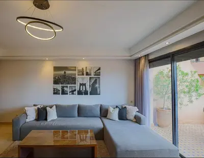 a living room with a blue couch and a table at Generosa studio in Marrakech