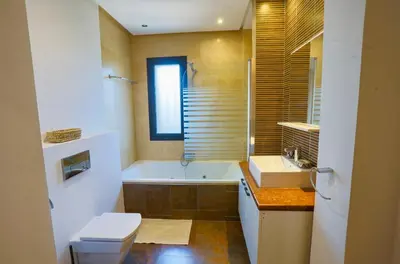 a bathroom with a tub and a toilet and a sink at Generosa 22 in Marrakech