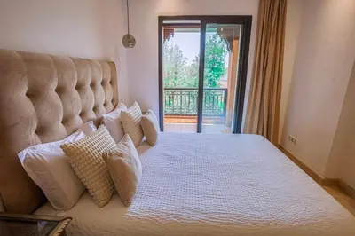 a bedroom with a large bed with pillows on it at Generosa 22 in Marrakech