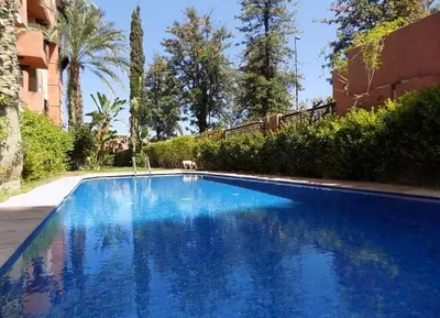 a large blue swimming pool next to a building at Generosa 22 in Marrakech