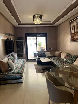 a living room with two couches and a table at GUELIZ 2 chambres 1 terrasse proche majorelle in Marrakech