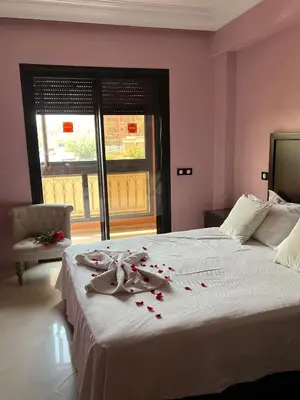 a bedroom with a bed with rose petals on it at GUELIZ 2 chambres 1 terrasse proche majorelle in Marrakech