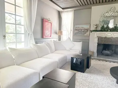 a living room with a white couch and a fireplace at Yasira in Marrakech