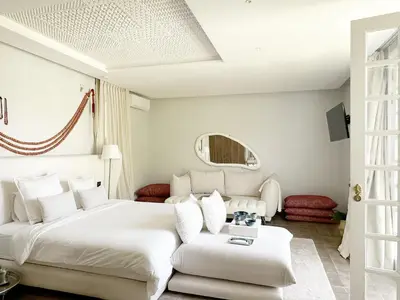 a bedroom with a large white bed and a couch at Yasira in Marrakech