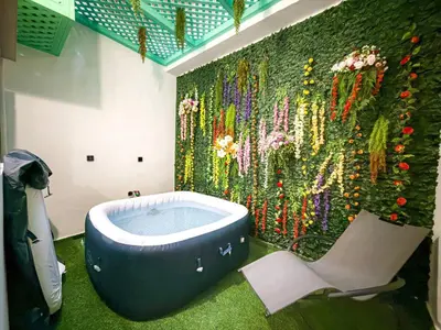 a bathroom with a bath tub and a colorful shower curtain at Séjour chic en ville Jacuzzi privé et Wi-Fi gratuit in Marrakech