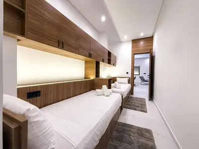 a room with a row of white beds at Séjour chic en ville Jacuzzi privé et Wi-Fi gratuit in Marrakech