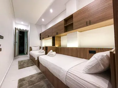 a bedroom with two beds in a room at Séjour chic en ville Jacuzzi privé et Wi-Fi gratuit in Marrakech