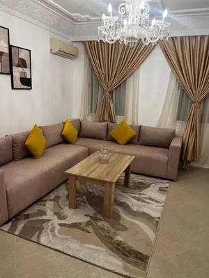 a living room with a couch and a coffee table at Apartement Mabrouka in Marrakech