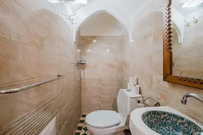 a bathroom with a toilet and a sink and a mirror at Riad Mazouz102 Médina in Marrakech