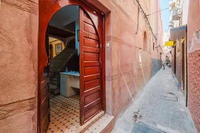 an alley with an open door in a building at Riad Mazouz102 Médina in Marrakech