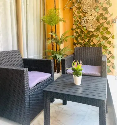 two wicker chairs and a table on a patio at Appartement Gueliz in Marrakech