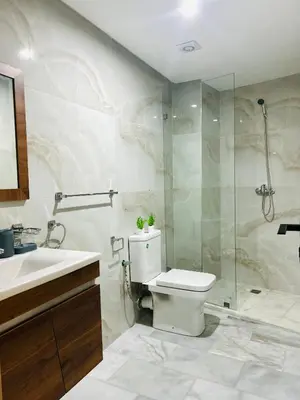 a bathroom with a toilet and a shower and a sink at Appartement Gueliz in Marrakech