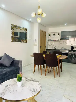 a living room with a couch and a table at Appartement Gueliz in Marrakech