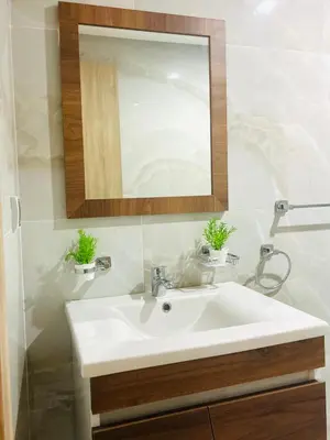 a bathroom with a white sink and a mirror at Appartement Gueliz in Marrakech