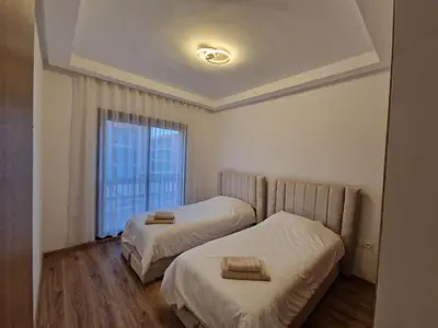 two beds in a small room with a window at Noria Isli Dar Noor in Marrakech