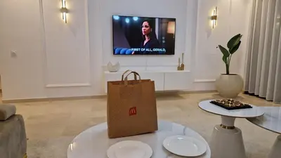 a shopping bag sitting on a coffee table in a living room at Noria Isli Dar Noor in Marrakech