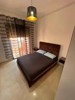 a bedroom with a bed and a large window at Apparemment première village in Marrakech