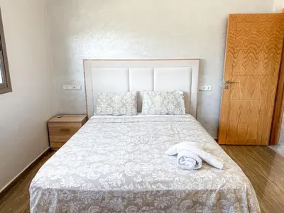 a bedroom with a bed with a towel on it at Villa with private pool in Marrakech