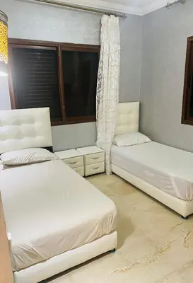 a bedroom with two beds and a window at Villa privée in Marrakech
