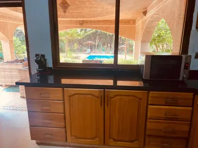a kitchen with a counter and a large window at Villa privée in Marrakech