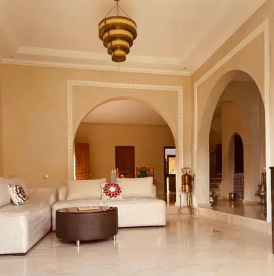 a living room with a couch and a table at Villa privée in Marrakech
