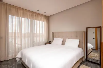 a bedroom with a white bed and a large window at 3Br 2Ba Apartment in Marrakech in Marrakech