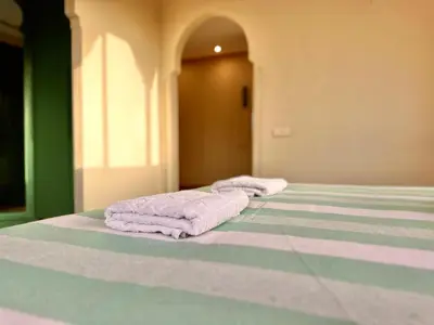 two towels sitting on a bed in a room at Villa Luxueuse avec Piscine & Vue sur le Golf in Marrakech