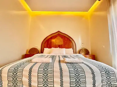 a bedroom with a large bed with two towels on it at Villa Luxueuse avec Piscine & Vue sur le Golf in Marrakech