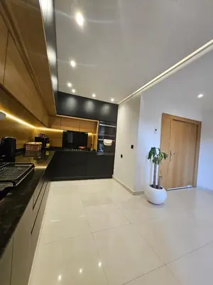 a kitchen with black and white counters and a vase with a plant at Luxury appartment hivernage in Marrakech