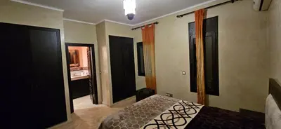 a bedroom with a bed and some doors and windows at Riad-Style Villa in Marrakech in Marrakech