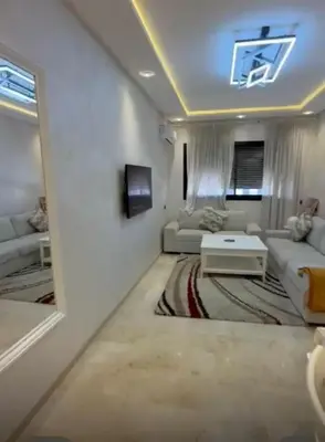 a living room with a couch and a table at شقة رائعة في جليز خاصة بالعائلات in Marrakech