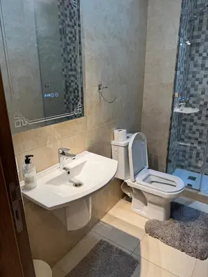 a bathroom with a toilet and a sink and a shower at شقة رائعة في جليز خاصة بالعائلات in Marrakech