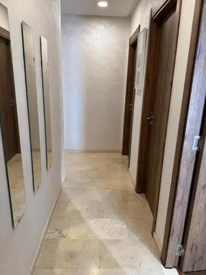 a hallway with two mirrors on the walls and a hallwayngthngthngthngthngth at شقة رائعة في جليز خاصة بالعائلات in Marrakech
