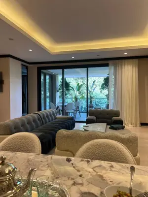 a living room with couches and chairs and a table at Four Seasons Residences Marrakech in Marrakech