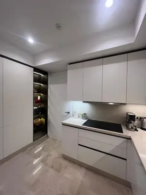 a kitchen with white cabinets and a counter top at Four Seasons Residences Marrakech in Marrakech