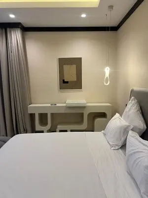 a bedroom with a white bed and a desk at Four Seasons Residences Marrakech in Marrakech