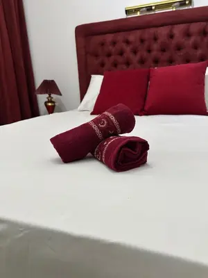 a pair of red pillows on a white bed at Dar Al Amina in Marrakech
