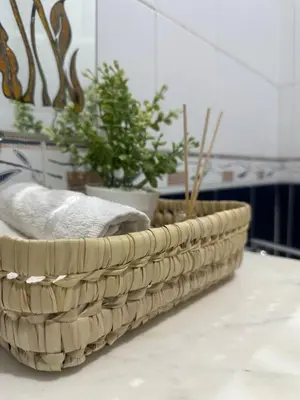 a basket with potted plants on a table at Dar Al Amina in Marrakech