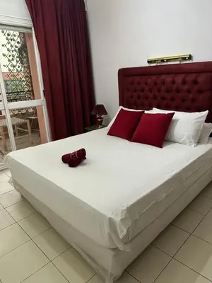 a bed with a red hat sitting on top of it at Dar Al Amina in Marrakech