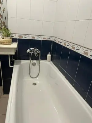 a white bath tub with a faucet in a bathroom at Dar Al Amina in Marrakech