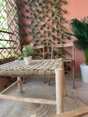 a rattan bench with a potted plant on it at Dar Al Amina in Marrakech