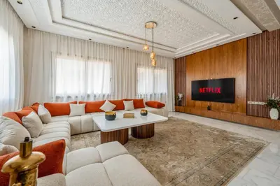 a living room with a couch and a tv at Villa Lina in Marrakech