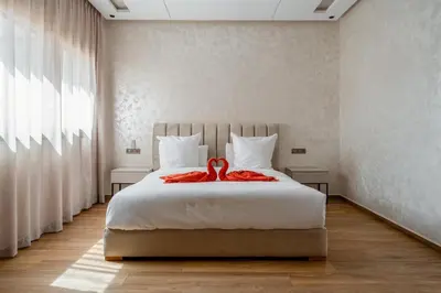 a bedroom with a bed with a red ribbon on it at Villa Lina in Marrakech