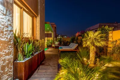 a house with a patio with a bench and plants at Villa Lina in Marrakech