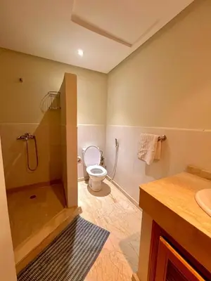 a bathroom with a toilet and a shower and a sink at Jassman2 in Marrakech