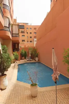 a swimming pool in the middle of a building at Jassman2 in Marrakech