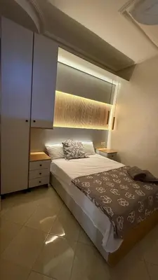 a bedroom with a large bed and a mirror at Résidence touristique Marrakesh in Marrakech