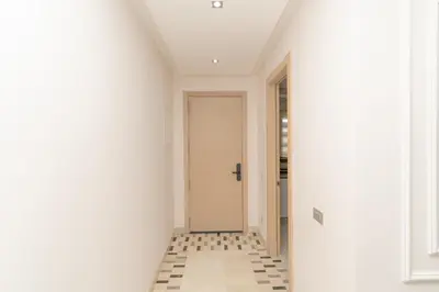 a hallway with a door and a tile floor at appartement luxe golf prestigia in Marrakech